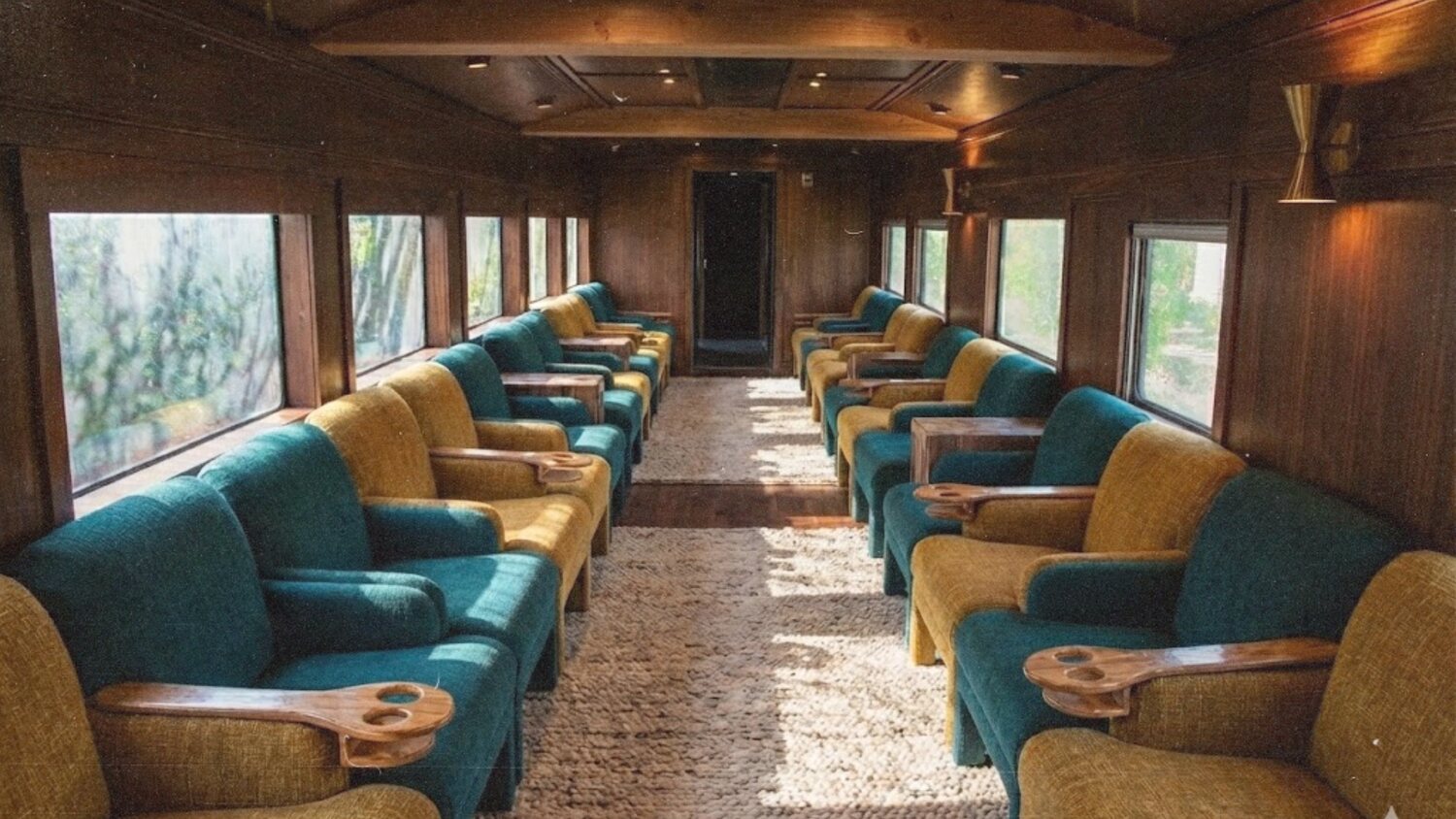 Rendered parlor car interior with teal and mustard seats and wood paneling